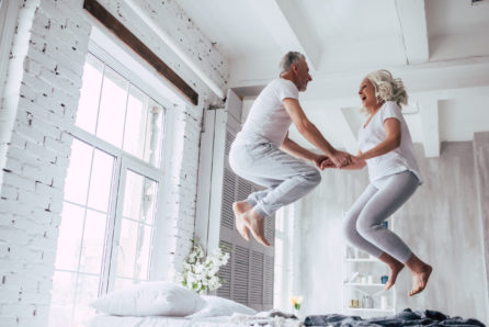 Older Couple Laughing and Jumping